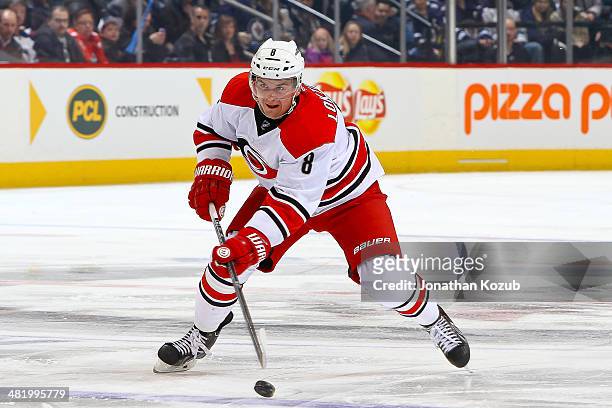 Andrei Loktionov of the Carolina Hurricanes shoots the puck down the ice during first period action against the Winnipeg Jets at the MTS Centre on...