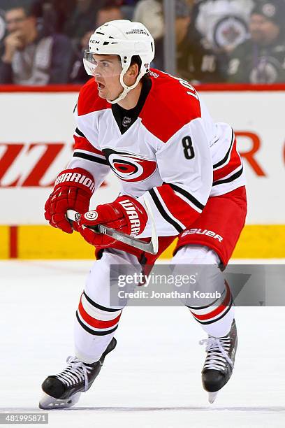 Andrei Loktionov of the Carolina Hurricanes follows the play up the ice during first period action against the Winnipeg Jets at the MTS Centre on...