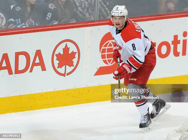 Andrei Loktionov of the Carolina Hurricanes keeps an eye on the play during second period action against the Winnipeg Jets at the MTS Centre on March...