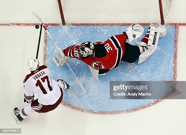 Martin Brodeur of the New Jersey Devils makes a save in the shootout against Radim Vrbata of the Phoenix Coyotes at the Prudential Center on March...