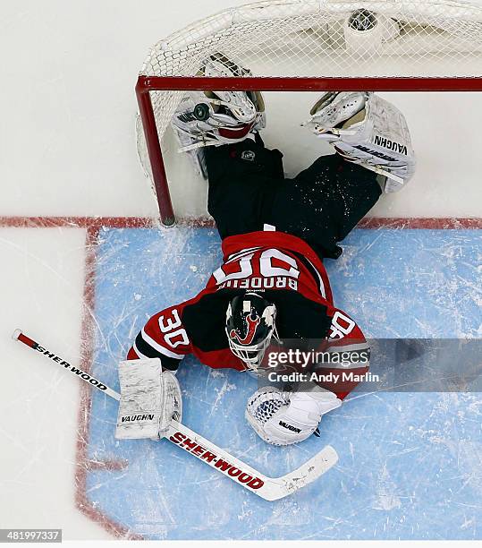 Martin Brodeur of the New Jersey Devils reacts after giving up a goal against the Phoenix Coyotes at the Prudential Center on March 27, 2014 in...