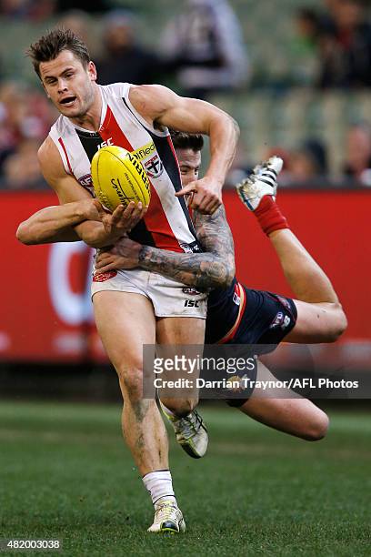 Jeremy Howe of the Demons tackles Maverick Weller of the Saints during the round 17 AFL match between the Melbourne Demons and the St Kilda Saints at...