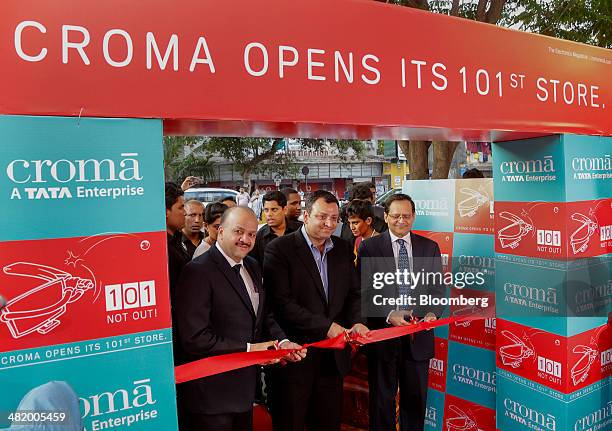 Cyrus Mistry, chairman of Tata Group, center, cuts a ribbon at the opening of Croma's 101st electronics megastore, operated by Tata Group's Infiniti...