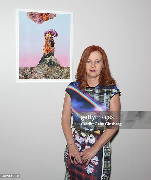 Artist J.K. Russ stands next to her mixed media art piece titled "Spring Romance" during Vegas Magazine's "Art Of The City" issue celebration at The...