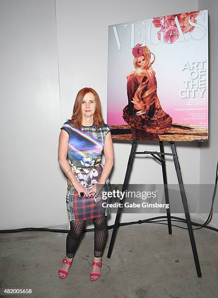 Artist J.K. Russ stands next to an image of her Vegas Magazine cover during Vegas Magazine's "Art Of The City" issue celebration at The Cosmopolitan...