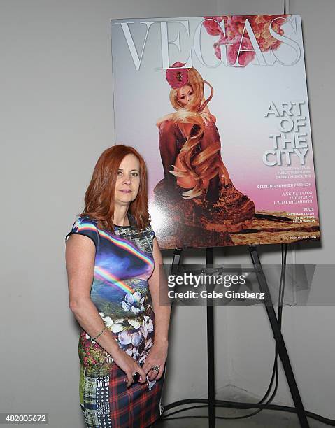 Artist J.K. Russ stands next to an image of her Vegas Magazine cover during Vegas Magazine's "Art Of The City" issue celebration at The Cosmopolitan...