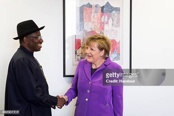 In this handout photo provided by the German Government Press Office German Chancellor Angela Merkel speaks with President of Nigeria Goodluck...