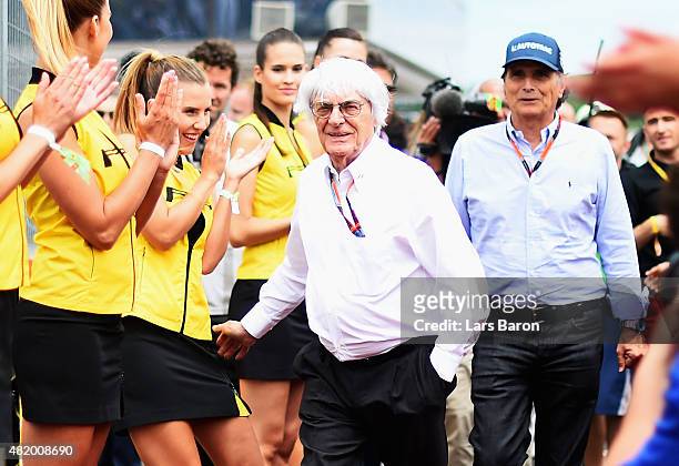 Supremo Bernie Ecclestone jokes with a grid girl during the drivers' parade before the Formula One Grand Prix of Hungary at Hungaroring on July 26,...