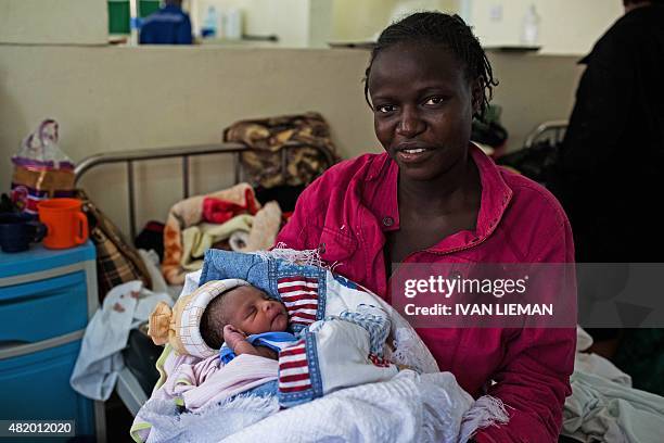 Millicent Akinyo holds her new born baby girl, named 'Michelle' in honour of US First Lady Michelle Obama, at the Mbagathi Hospital in Nairobi on...