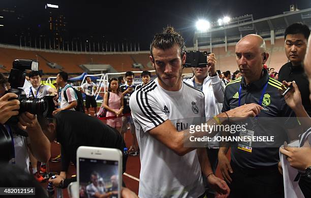 Real Madrid's Gareth Bale signs autographs after a training session on the eve of the International Champions Cup football match between Inter Milan...