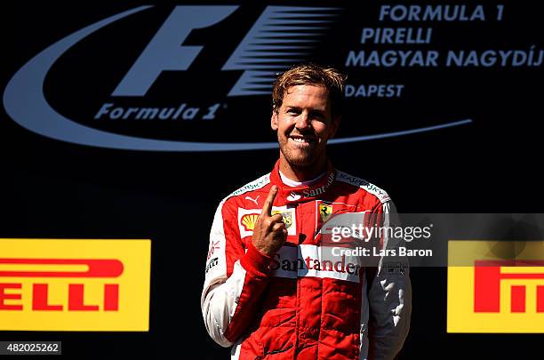 Sebastian Vettel of Germany and Ferrari celebrates on the podium after winning the Formula One Grand Prix of Hungary at Hungaroring on July 26, 2015...