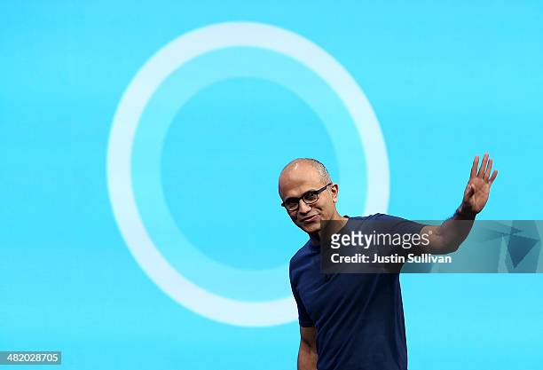 Microsoft CEO Satya Nadella walks in front of the new Cortana logo as he delivers a keynote address during the 2014 Microsoft Build developer...