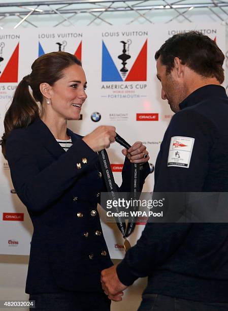 Catherine, Duchess of Cambridge presents a medal to Sir Ben Ainslie, skipper of Britain's Land Rover-backed BAR team, at the close of the British leg...