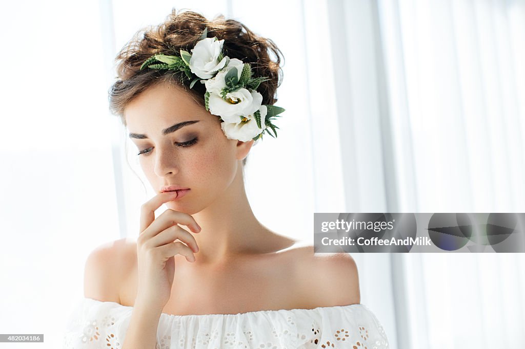 Studio shot of young beautiful bride on light background