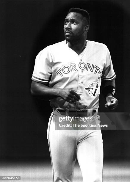 Joe Carter of the Toronto Blue Jays runs off the field circa 1990s.