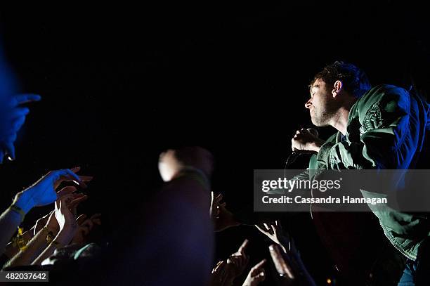 Damon Albarn of the band Blur jumps into the crowd as he performs for fans during Splendour in the Grass on July 26, 2015 in Byron Bay, Australia.