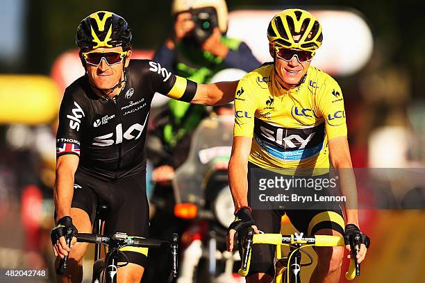 Chris Froome of Great Britain and Team Sky celebrates overall victory with team mate Geraint Thomas of Great Britain and Team Sky following the...