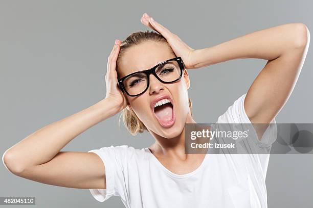 angry blond hair young woman screaming - word of mouth stock pictures, royalty-free photos & images