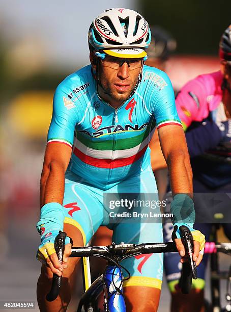 Tour de France winner Vincenzo Nibali of Italy and Astana Pro Team crosses the finish line at the end of the twenty first stage of the 2015 Tour de...