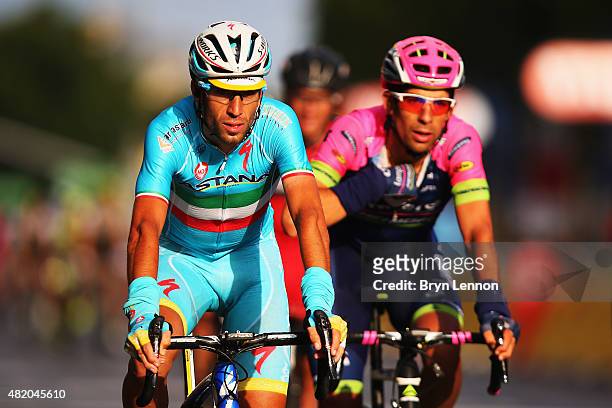 Tour de France winner Vincenzo Nibali of Italy and Astana Pro Team crosses the finish line at the end of the twenty first stage of the 2015 Tour de...