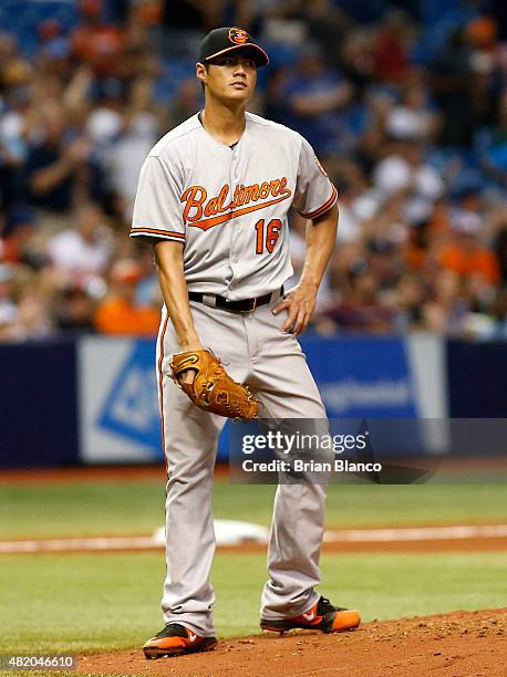 Pitcher Wei-Yin Chen of the Baltimore Orioles reacts on the mound after giving up a home run to Logan Forsythe of the Tampa Bay Rays on his first...