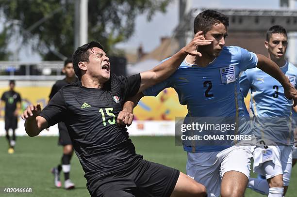 Michael Perez of Mexico vies for the ball with Carlos Guzman of Uruguay during their gold medal football match of the Pan American Games, in...