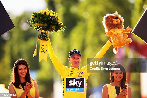 Chris Froome of Great Britain and Team Sky celebrates in the yellow jersey on the podium after overall win following the twenty first stage of the...