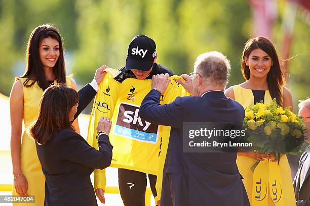 Tour de France winner Chris Froome of Great Britain and Team Sky receives the yellow jersey on the podium after his overall victory following the...