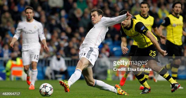Gareth Bale of Real Madrid scores the first goal during the UEFA Champions League Quarter Final first leg match between Real Madrid and Borussia...