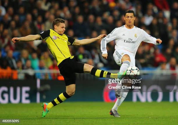 Cristiano Ronaldo of Real Madrid is tackled by Lukasz Piszczek of Borussia Dortmund during the UEFA Champions League Quarter Final first leg match...
