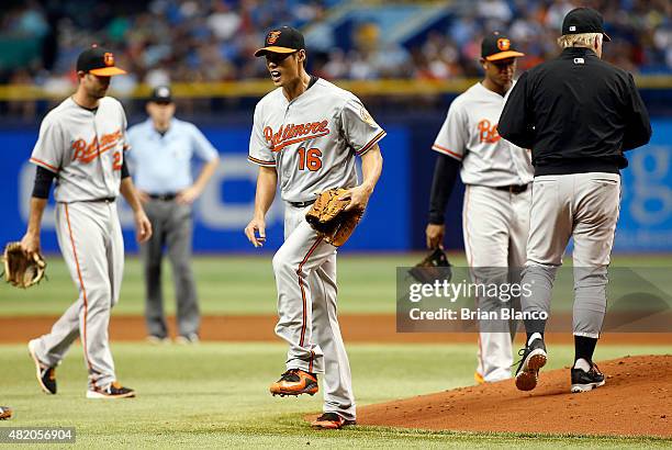 Pitcher Wei-Yin Chen of the Baltimore Orioles reacts as he is taken off the mound by manager Buck Showalter during the sixth inning of a game against...