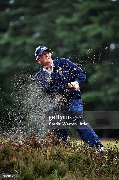 Colin Montgomerie of Scotland plays his second shot on the 12th hole from the top of a fairway bunker during the final round of The Senior Open...