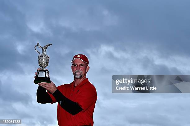 Marco Dawson of the USA poses with the trophy after winning The Senior Open Championship on the Old Course at Sunningdale Golf Club on July 26, 2015...