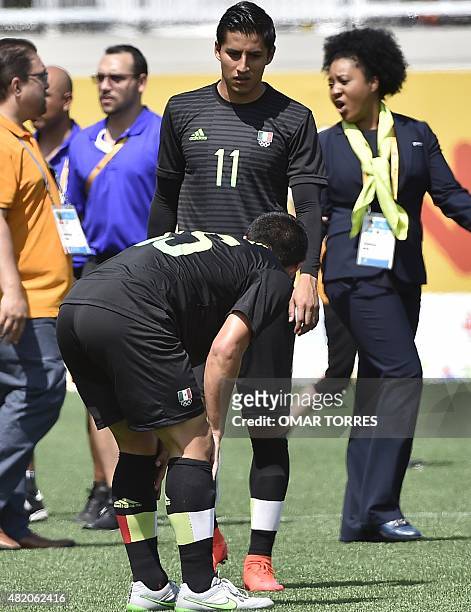 Mexico's Michael Perez and Carlos Cisneros are pictured after being defeated by Uruguay in the final of the Pan American Games football competition,...