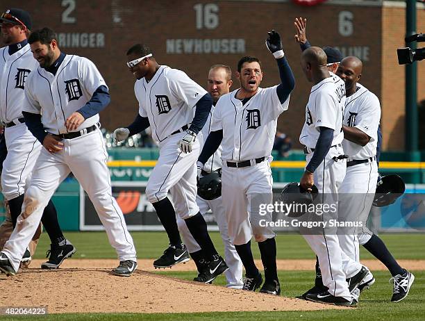Ian Kinsler of the Detroit Tigers celebrates with teammates after his 10th inning game winning single to beat the Kansas City Royals 2-1 at Comerica...