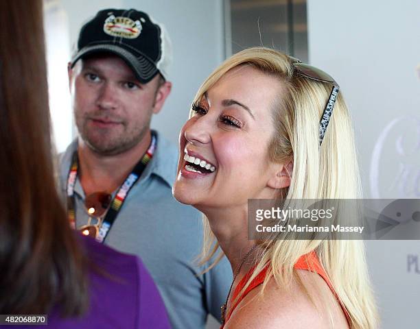 Brickyard 400 namesake Jeff Kyle with his with Amy Kyle presents a bottle of Crown Royal XR to Kellie Pickler and Kyle Jacobs at Indianapolis Motor...