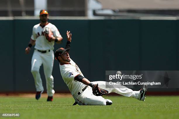 Gregor Blanco of the San Francisco Giants catches a fly ball off the bat of Billy Burns of the Oakland Athletics in the first inning at AT&T Park on...