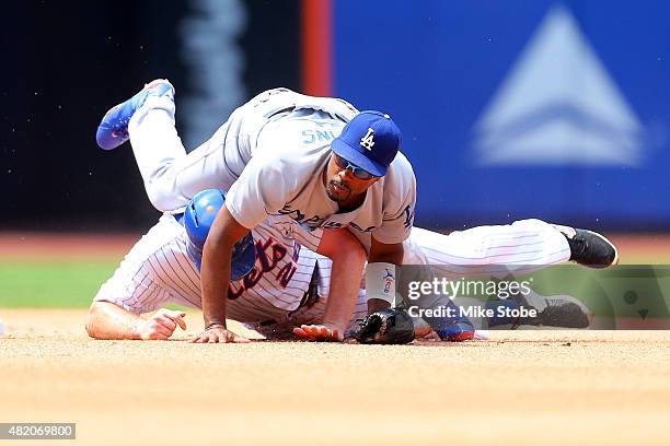 Daniel Murphy of the New York Mets is forced out at second as Jimmy Rollins of the Los Angeles Dodgers completes the double play at Citi Field on...