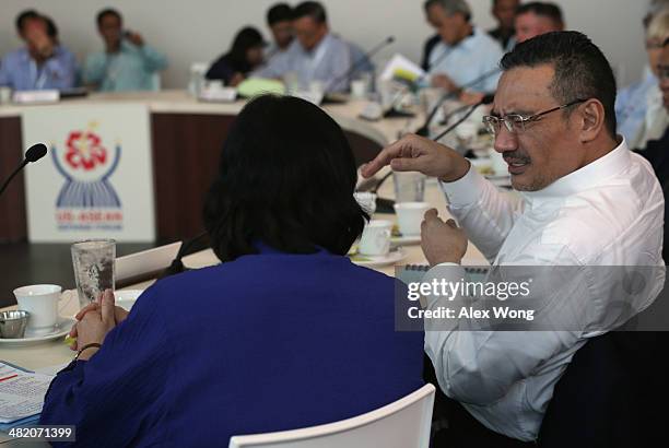 Defense Minister and Acting Transport Minister of Malaysia Hishammuddin Hussein talks to a participant during a minister roundtable April 2, 2014 in...