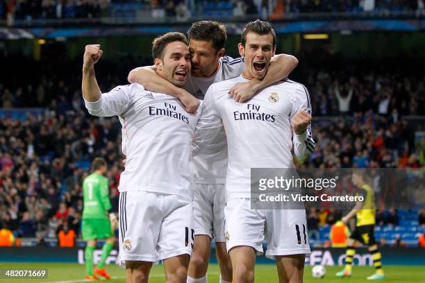 Gareth Bale of Real Madrid celebrates after scoring the opening goal with his teammates Daniel Carvajal and Xabi Alonso during the UEFA Champions...