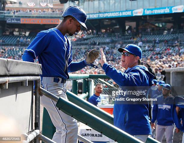 Pedro Ciriaco of the Kansas City Royals celebrates scoring a game-tying run in the ninth inning with manager Ned Yost while playing the Detroit...
