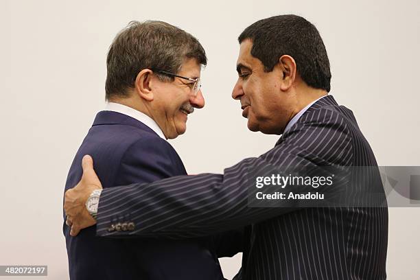 Turkey's Foreign Minister Ahmet Davutoglu hugs the United Nations High Representative for the Alliance of Civilizations, Nassir Abdulaziz Al-Nasser...