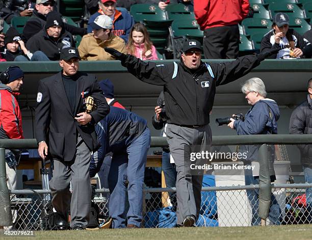 Third base umpire Dale Scott , with home plate umpire Dan Iassogna, signals safe after a call was overturned by instant replay during the seventh...