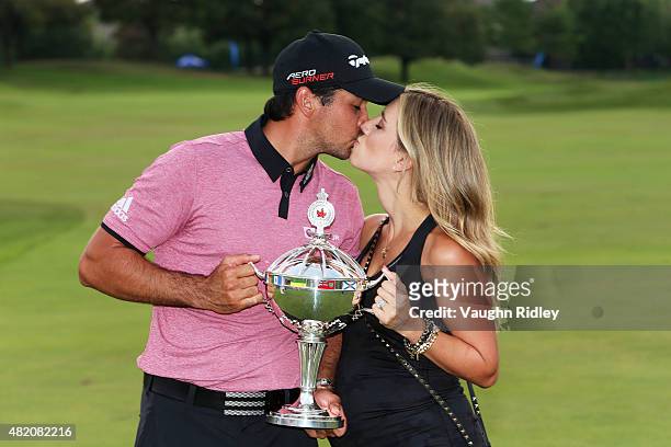 Jason Day of Australia celebrates with the winner's trophy and his wife Ellie after the final round of the RBC Canadian Open at Glen Abbey Golf Club...