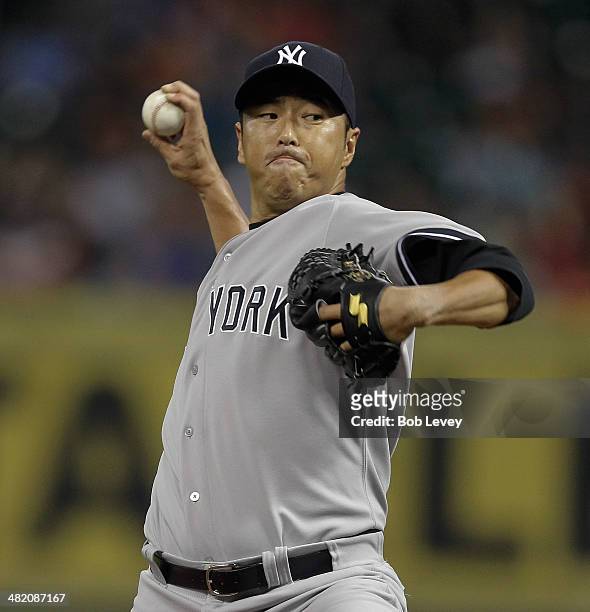 Hiroki Kuroda of the New York Yankees throws in the first inning against the Houston Astros at Minute Maid Park on April 2, 2014 in Houston, Texas.