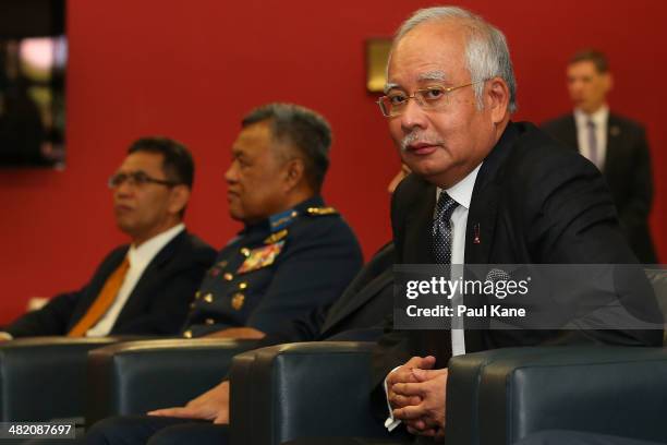 Malaysian Prime Minister Najib Razak looks on as Air Chief Marshall Angus Houston commence his briefing about the search mission for the missing...