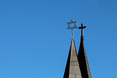Side by side spires with cross and star of david