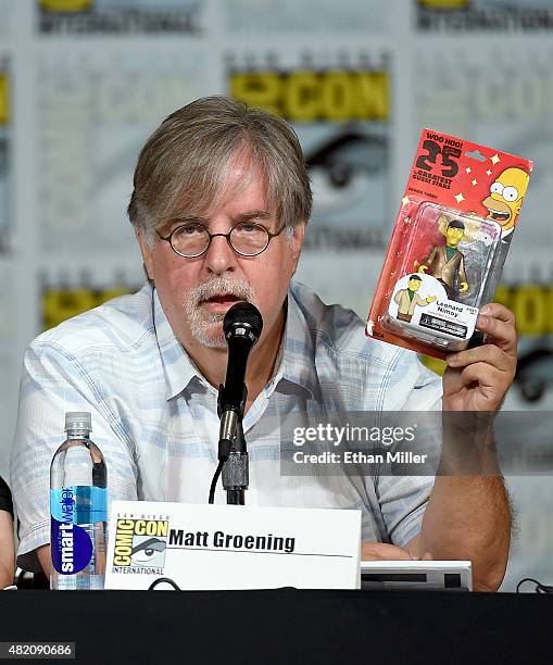 Producer/writer Matt Groening gives away a Leonard Nimoy figure as he attends "The Simpsons" panel during Comic-Con International 2015 at the San...