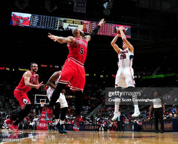 Cartier Martin of the Atlanta Hawks shoots against Carlos Boozer of the Chicago Bulls on April 2, 2014 at Philips Arena in Atlanta, Georgia. NOTE TO...