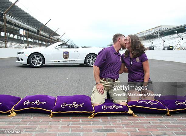 Marine Corps Sergeant Jeff Kyle with wife Amy Kyle poses on the Yard of Bricks Following the Crown Royal Presents The Jeff Kyle 400 At The Brickyard...